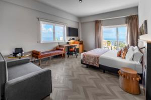 a hotel room with a bed and a couch at TUI BLUE Atlantic Hills in Puerto de la Cruz