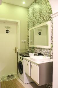 a bathroom with a sink and a washing machine at HOMEY iNN in Medina +33 photos