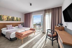 a hotel room with a bed and a balcony at TUI BLUE Atlantic Hills in Puerto de la Cruz +74 photos