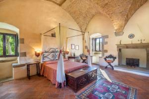 a bedroom with a bed and a fireplace at Tuscany Tower Villa in Capolona +11 photos