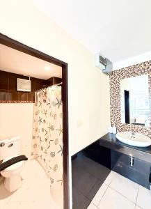 a bathroom with a toilet and a sink at Thai Classic House in Patong Beach