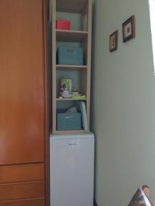 a white refrigerator in a kitchen next to a door at Camera con bagno in villa in Pieve Emanuele +8 photos