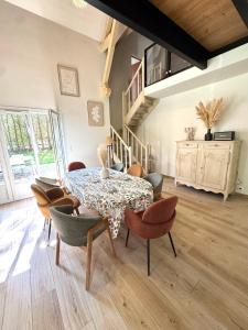 una sala da pranzo con tavolo e sedie di Ô Refuge de Théo et Vic' a Saint-Martin-du-Vieux-Bellême