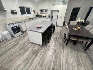 a large kitchen with a table and a dining room at Te Kopa Villa in Rarotonga