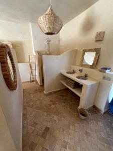 a room with a vanity and a mirror and a table at Villa'S in Zaouiet Bouzarktoune +97 photos