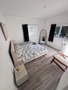a bedroom with a bed in the middle of the room at Te Kopa Villa in Rarotonga