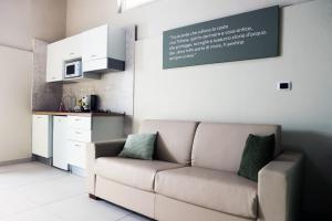a living room with a couch and a sign on the wall at Zibakhome in Monte di Procida