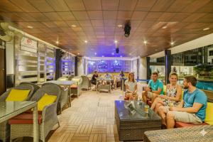 a group of people sitting in a restaurant at FabHotel Prime The King's Court - Nr Calangute Beach in Calangute