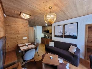 a living room with a couch and a table at ALPIN 7 Jasná - Free Jacuzzi & Sauna in Demanovska Dolina