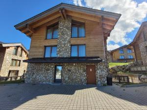 a large house with a stone facade at ALPIN 7 Jasná - Free Jacuzzi & Sauna in Demanovska Dolina