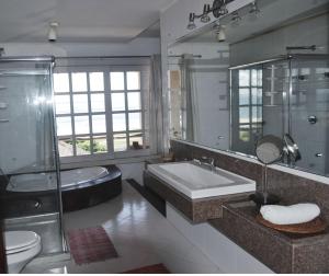 a bathroom with a sink and a shower and a tub at Pousada Chic N Choc in Morro de São Paulo +71 photos