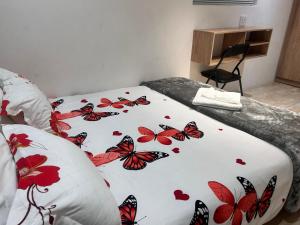 a bed with a blanket with butterflies on it at Jorash Guesthouse in Cape Town