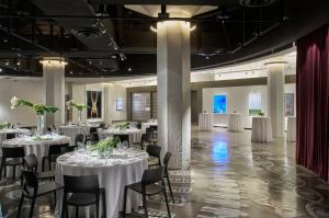 a banquet hall with white tables and chairs at Fordson Hotel, in the Unbound Collection by Hyatt in Oklahoma City