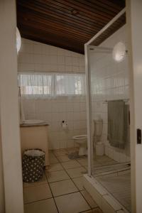 a bathroom with a toilet and a sink and a shower at Sea La Vie- beach cottage in Port Edward +39 photos