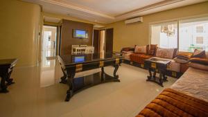 a living room with a table and a couch at Prestigia luxury appartement in Fès