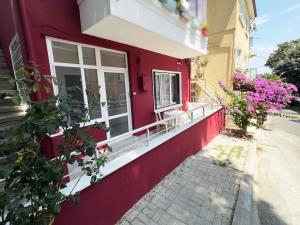 a red building with flowers on the side of it at Garden House Heybeliada in Adalar