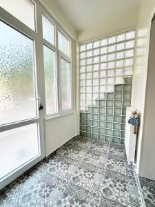 a bathroom with a window and a tiled floor at Garden House Heybeliada in Adalar