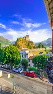 a view of a city with a castle on a hill at Appartement cosy face au château de Lourdes in Lourdes