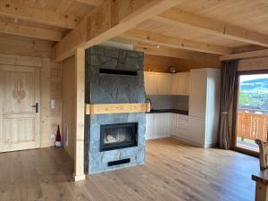 a large living room with a stone fireplace at Cicha Ostoja in Czarny Dunajec
