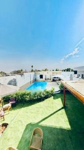 a patio with chairs and a swimming pool on a building at Al Mansi Luxury Retreat in Luxor +70 photos