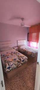 a bedroom with two beds and a window at Horizonte al Mar in Miramar