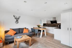 a living room with a couch and a table at Fewo Weitblick - Haus Sommerberg in Baiersbronn