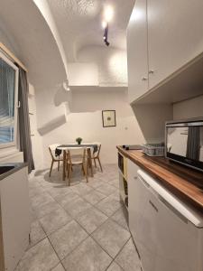 a kitchen with a table and a dining room at Walter Apartment City Center in Ljubljana