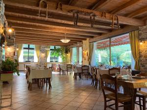 a dining room with tables and chairs in a restaurant at Hotel della valle in Vernante