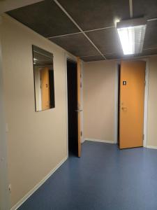 an empty room with two doors and a mirror at Monicas B&B in Hagfors +3 photos
