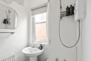 a white bathroom with a shower and a sink at Luxury, Comfy Home in Manchester Center in Manchester +36 photos