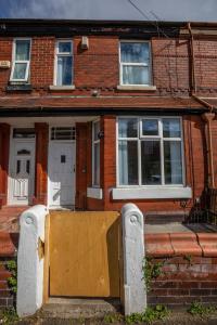 a wooden door in front of a brick house at Luxury, Comfy Home in Manchester Center in Manchester