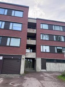 a brick building with a garage in front of it at Loft apartment in Kouvola