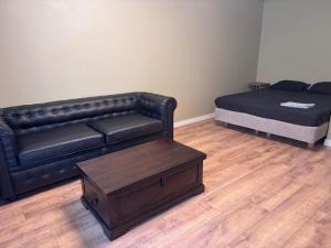 a living room with a couch and a bed at Loft apartment in Kouvola