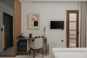 a bedroom with a desk with a chair and a bed at Elysian Castle in Ioannina