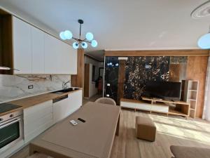 a kitchen with a table and a dining room at Rafaele in Shëngjin