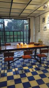a dining room with a table and chairs on a checkered floor at H & R Villa Yogyakarta in Manisrenggo