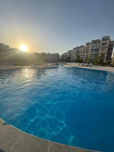 ein großer Pool mit blauem Wasser vor einigen Gebäuden in der Unterkunft Sunny beach in Sharm El Sheikh