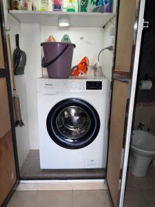 a washing machine with a bucket on top of it at Temporario Mitre in Vuelta del Paraguayo