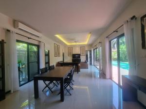 a dining room with a table and chairs in a house at Tara13-Oriental Villa 3BR private pool Layan Beach in Bang Tao Beach