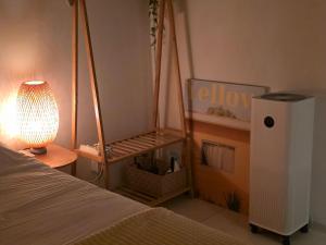 a bedroom with a bed and a lamp next to a bed gmaxwell gmaxwell at Stay EROB in Seoul
