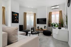a living room with a couch and a tv at Boheme Social Apartment in Bucharest