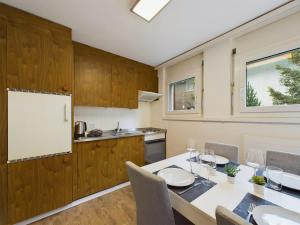 a kitchen with a table with chairs and a whiteboard at Pure Comfort! Entire Apartment with Abundant Space near Zermatt with parking! in Täsch