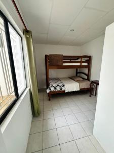 a bedroom with a bunk bed and a window at Casa vacacional en Salinas en Urb privada con parqueo piscina y jacuzzi in Salinas