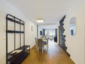 a dining room and living room with a table and chairs at Mountain magic apartment for 6 Near Zermatt with parking! in Täsch