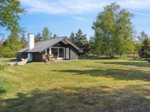 a small house in the middle of a field at Holiday Home Irlin - 600m from the sea by Interhome in Jerup