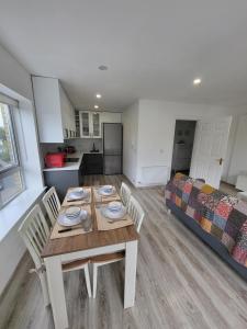 a room with a table and chairs and a bed at The Happy Thoughts Place in Celbridge +17 photos