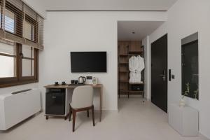 a kitchen with a desk and a tv in a room at Elysian Castle in Ioannina