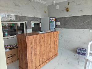 a kitchen with a wooden counter and a counter top at Chinnis Guest Inn in Nellore