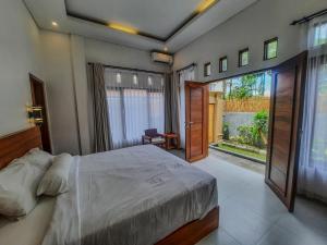 a bedroom with a large bed and a large window at San Villa Canggu - 3BR Private Pool & Fast Wifi in Dalung