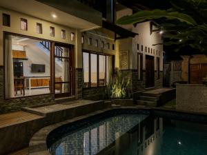 a house with a swimming pool in front of a house at San Villa Canggu - 3BR Private Pool & Fast Wifi in Dalung